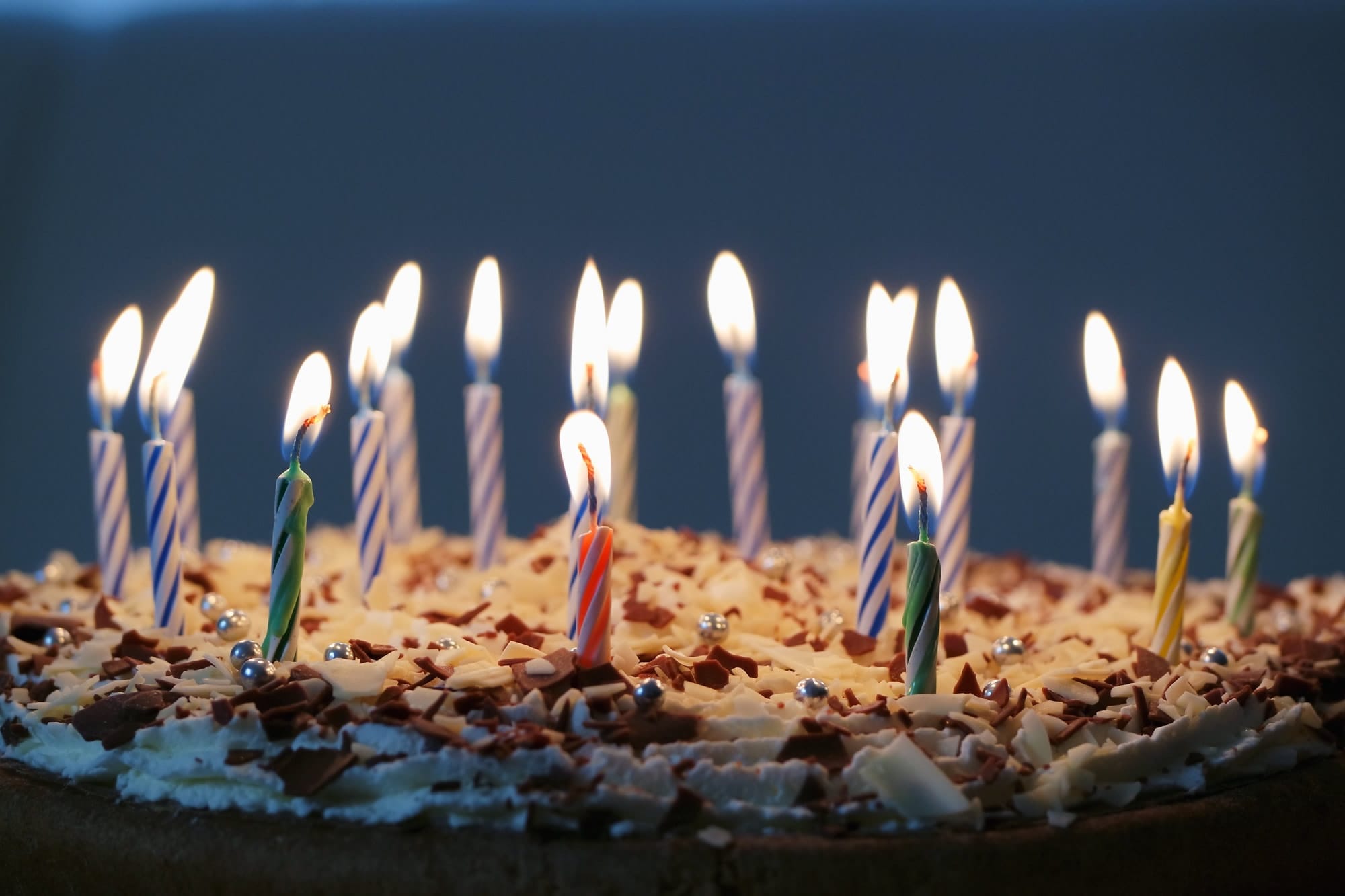chocolate and vanilla birthday cake with lit candles