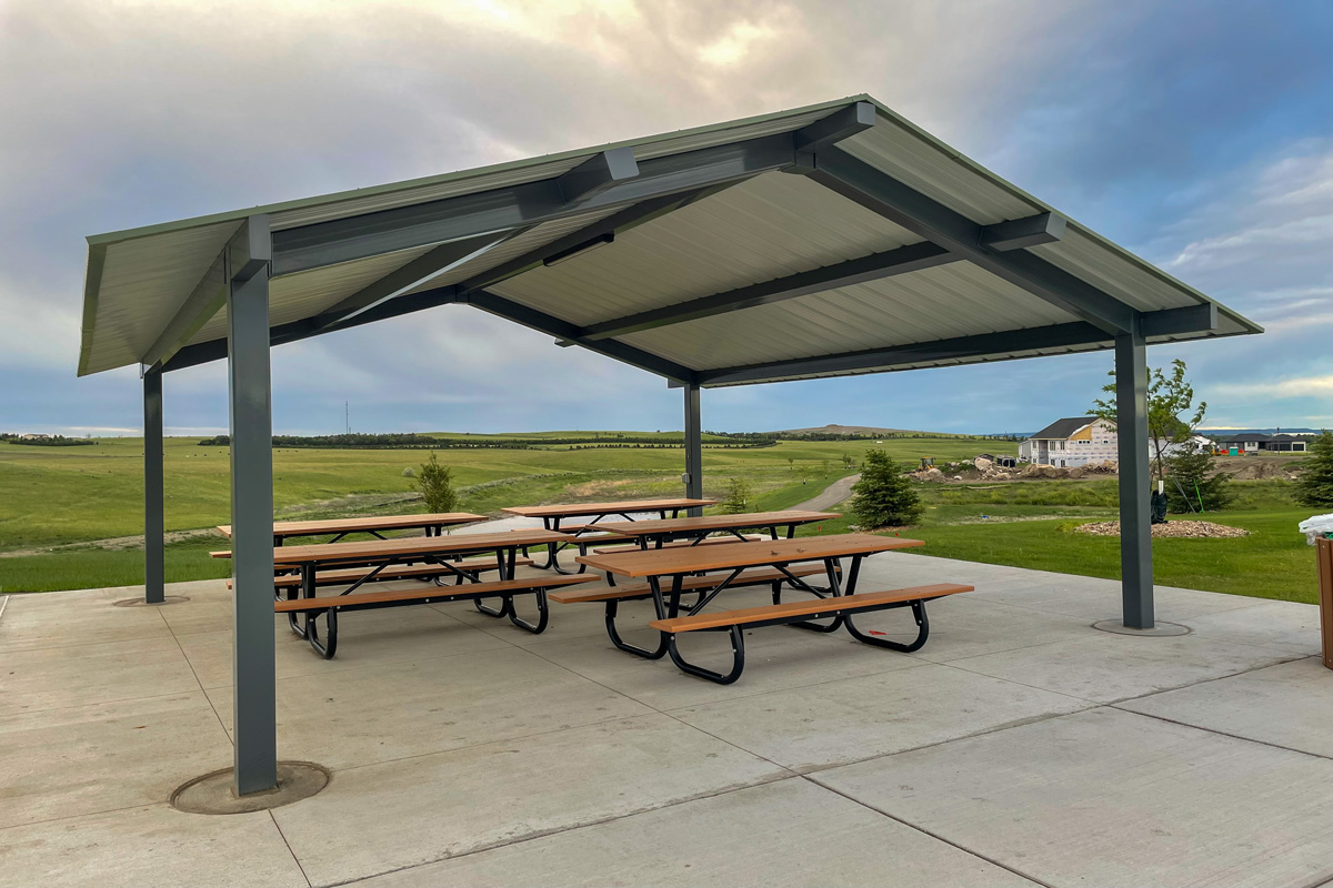 A. James Silbernagel Park shelter with four picnic tables underneath it