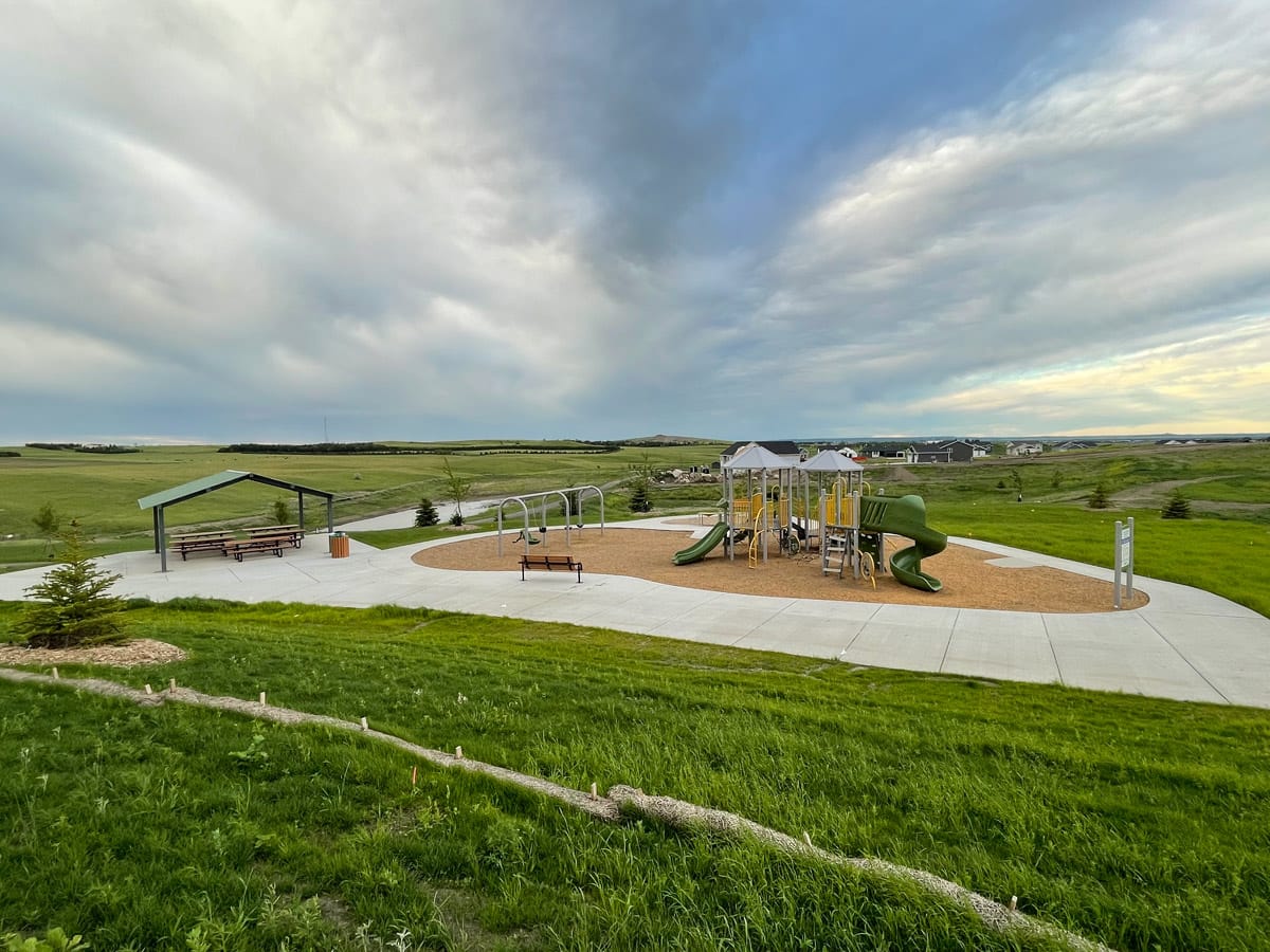wide angle view of the A. James Silbernagel Park, including a playground, swing set, and shelter