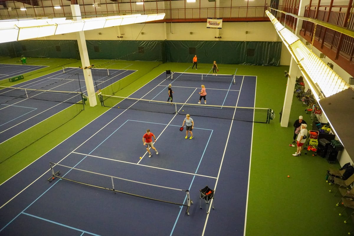 adults playing pickleball on two courts at CRFC