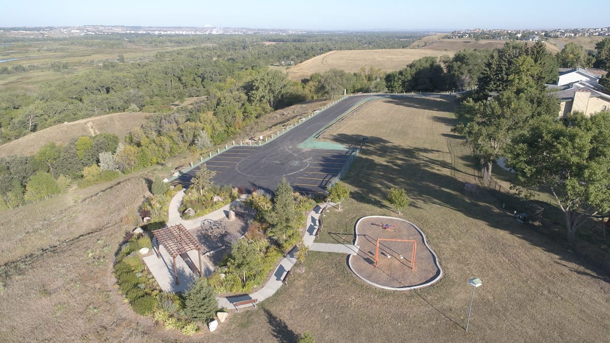 bird's eye view of the swing set, pergola, and parking lot at Chief Looking's Village