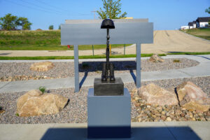 statue as part of heroes plaza at Heroes Park - combat boots, gun, and military hat