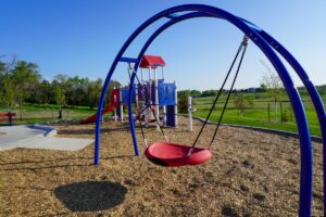 swing set and playground in background at Heroes Park