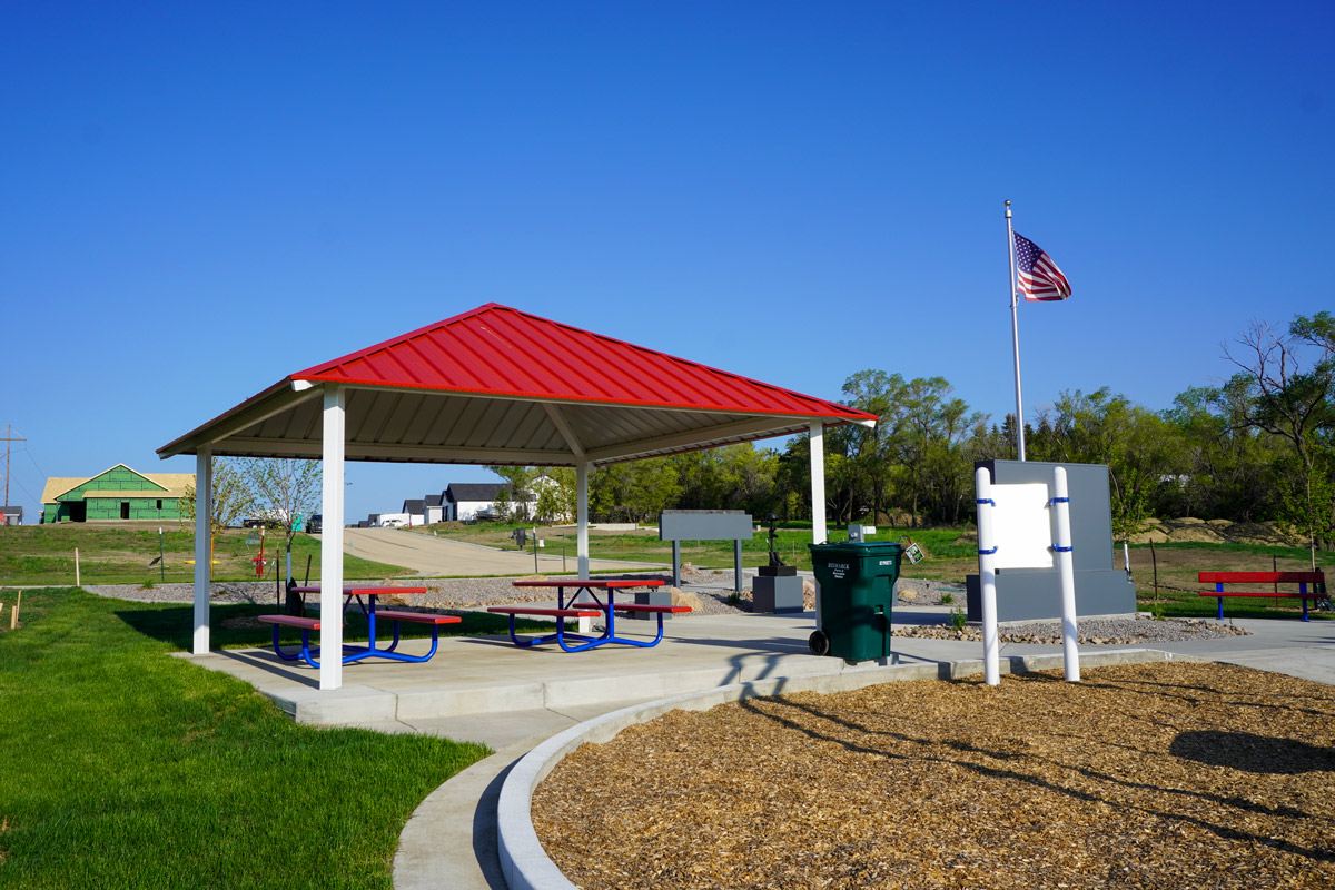 shelter at Heroes Park with American flag in the background