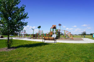 wide angle view of Hidden Star Park playground and bench
