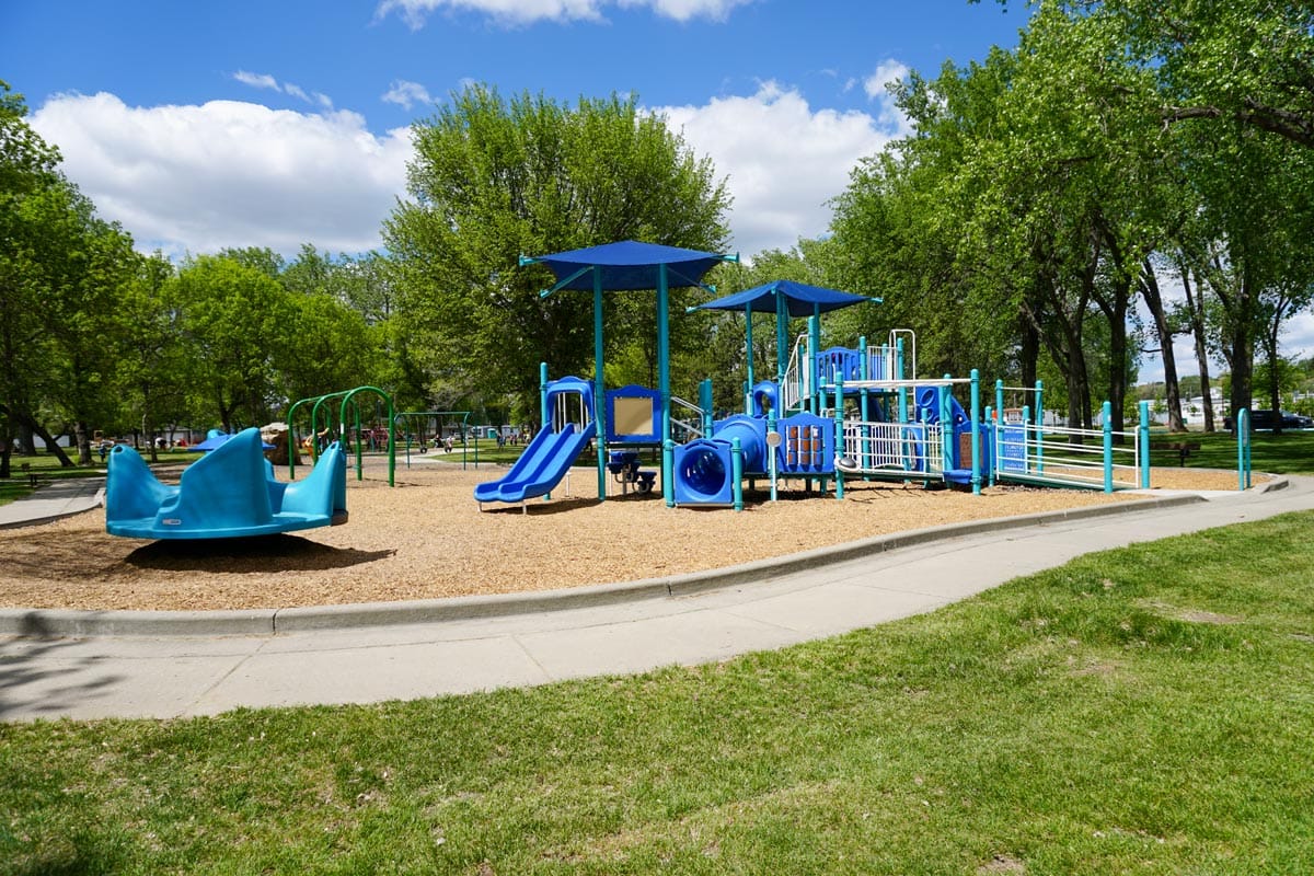 blue playground with trees in the background at Kiwanis Park