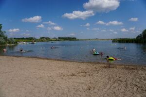 people enjoying the beach and water at McDowell Dam Recreation Area