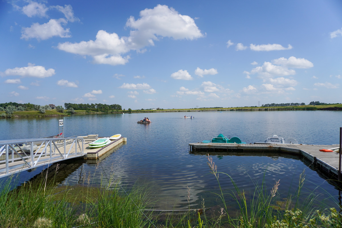 wide angle view of the water at McDowell Dam Recreation Area with a kayak launch and dock for pedal boats