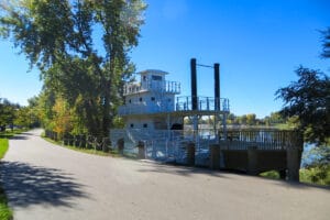 wide angle shot of the steamboat at Steamboat Park with trees and trail next to it