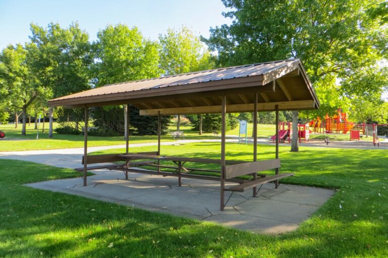 picnic shelter in a park with benches on both sides of the picnic table
