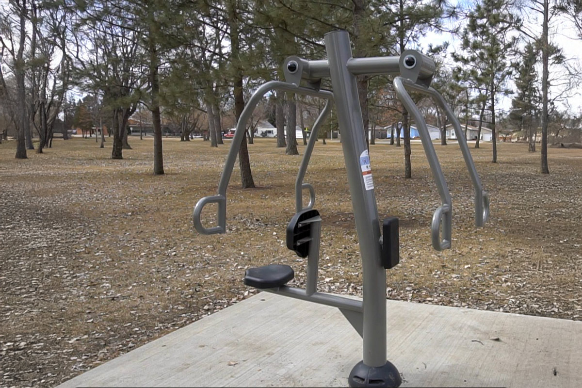 chest press fitness equipment in a park along a fitness trail