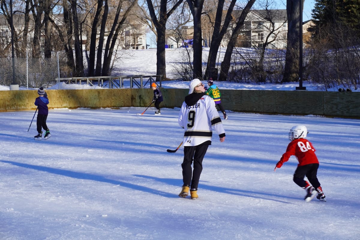 Bobcat hockey player on outdoor rink with other skaters