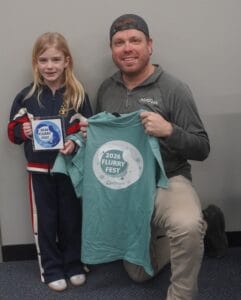 Nick Senne and daughter Willa with the Flurry Fest Treasure Hunt plaque and tshirt