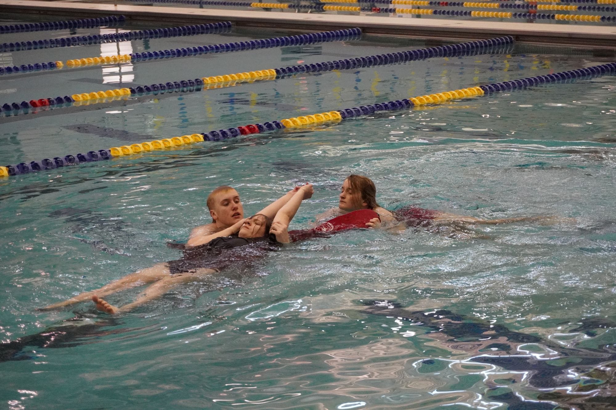 lifeguards in training practice a rescue in the pool