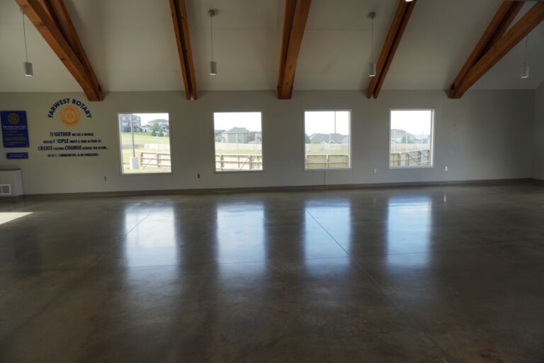 Farwest Rotary Community Center: a wall with Farwest Rotary information on it and four windows facing the ice skating rink.